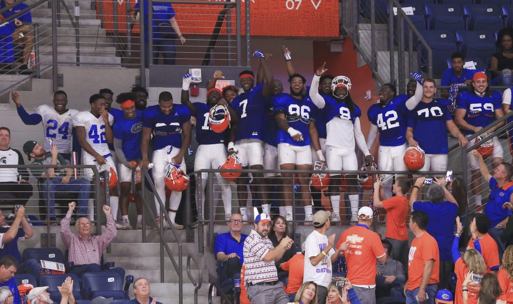 Florida Football Players Watch Gators Basketball Game In Full Pads
