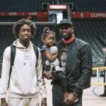 Dwyane Wade (right) poses for a photo with son Zaire (left) and Kaavia (center) at the Crypto.com Arena